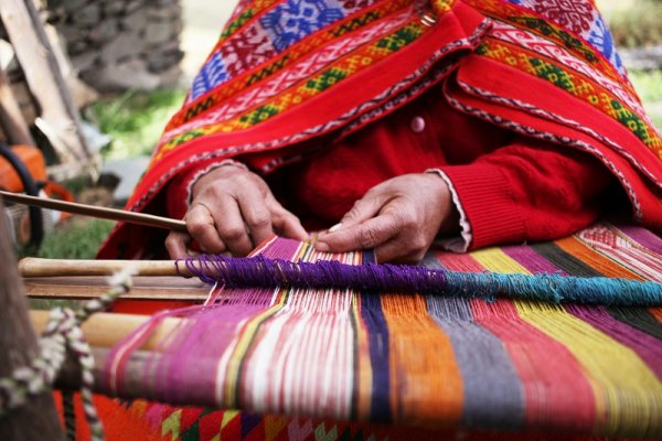 Peruvian woman making traditional clothes