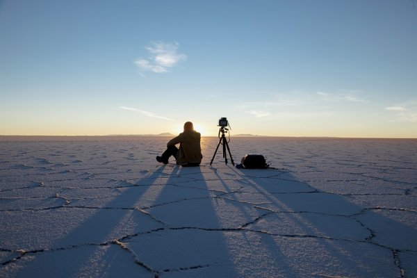 Photographer in the dried salt flats in Bolivia